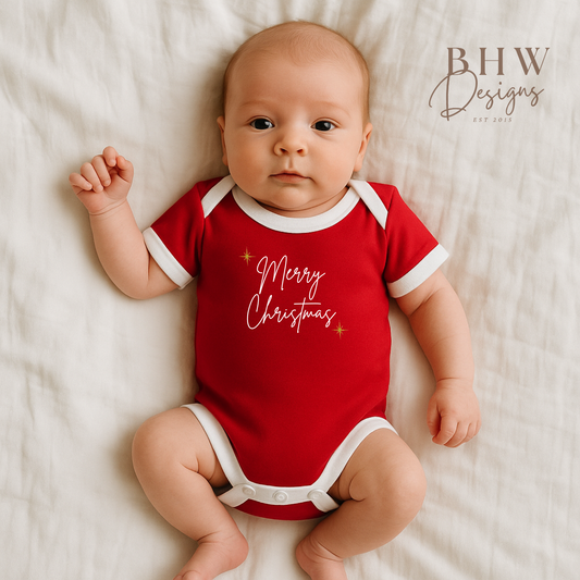Baby wearing a red 'Merry Christmas' onesie on a white background