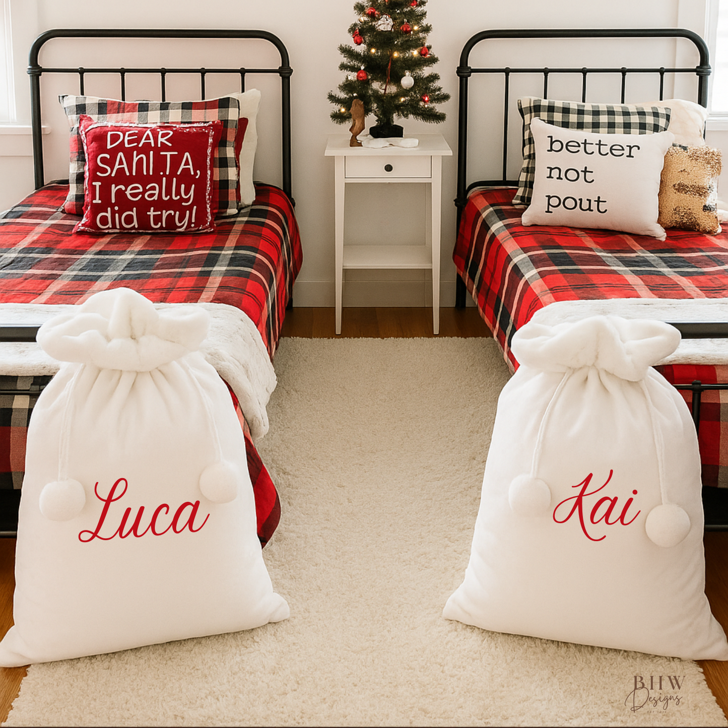 Children's bedroom with two beds, with two white Santa sacks with white faux fur trim and pom pom's with Luca and Kai on the front in red
