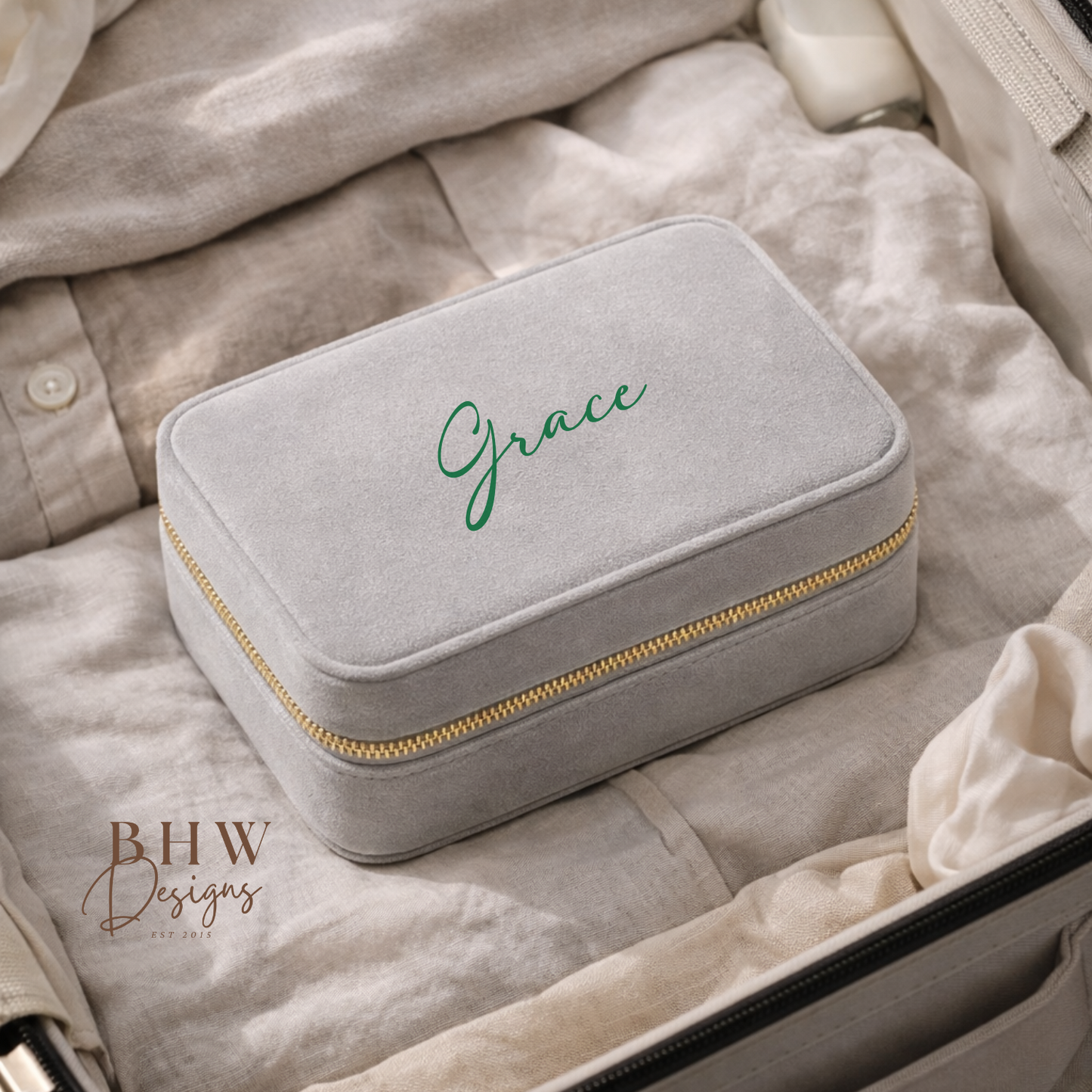 Grey jewellery box with 'Grace' on the top in a suitcase, 