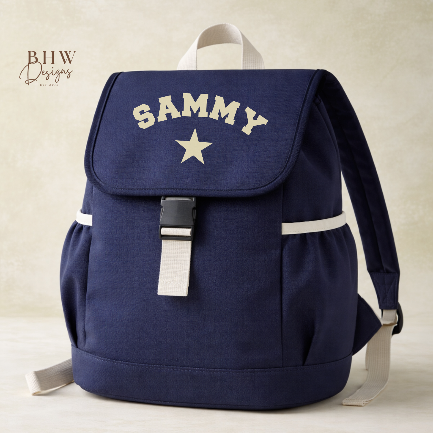 Navy blue backpack with 'SAMMY' and a star on a beige background