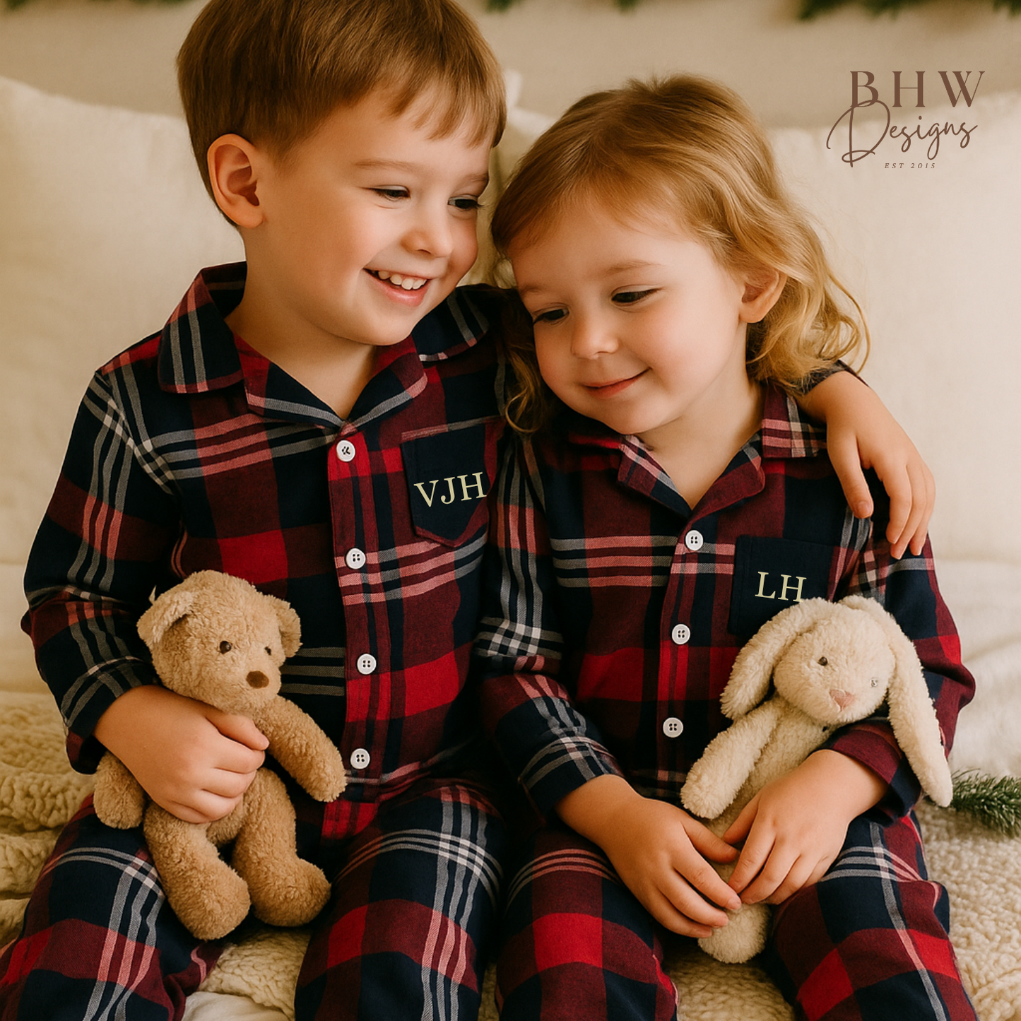two children wearing red and blue plaid onesie with 'VJH' and LH in cream on the front