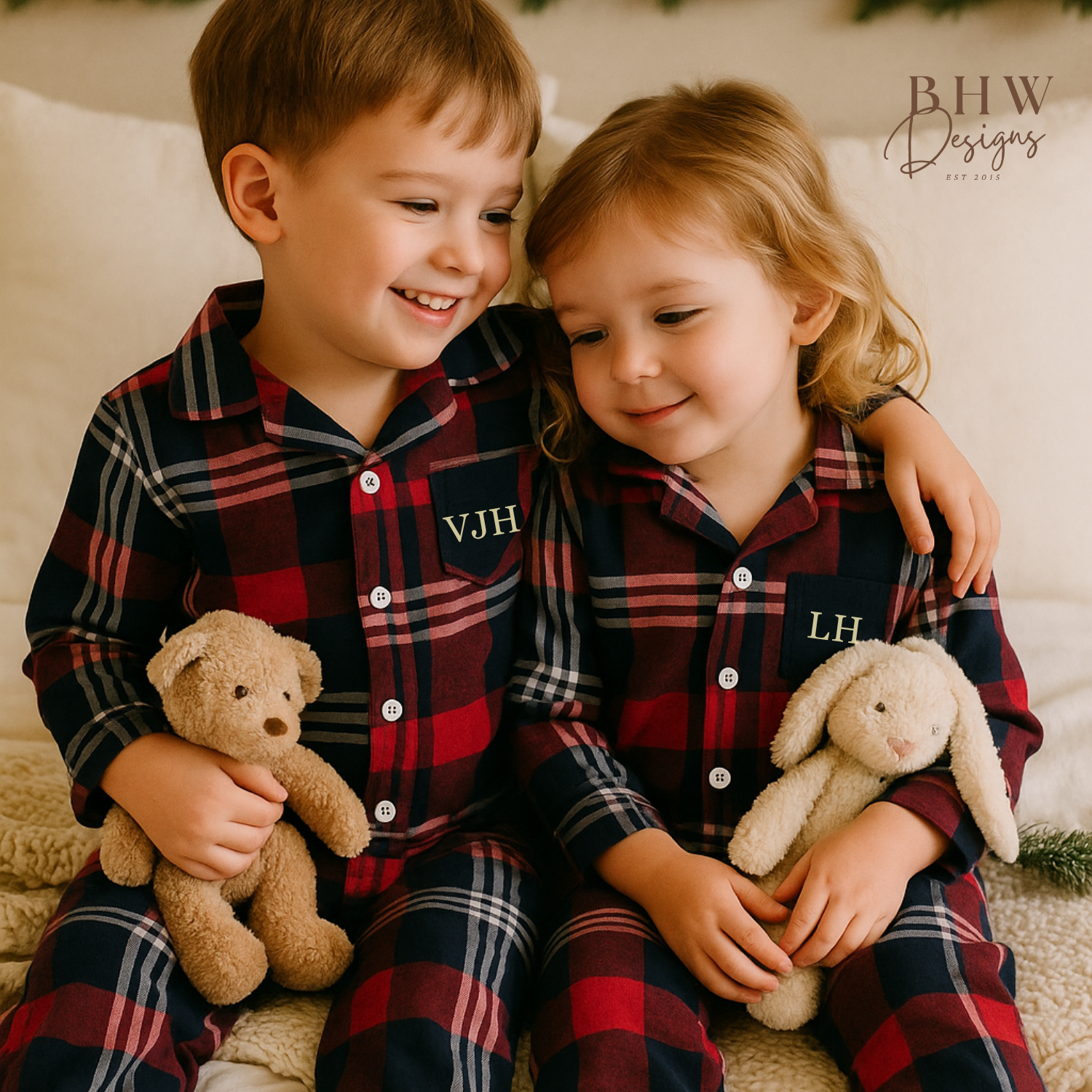 two children wearing red and blue plaid onesie with 'VJH' and LH in cream on the front