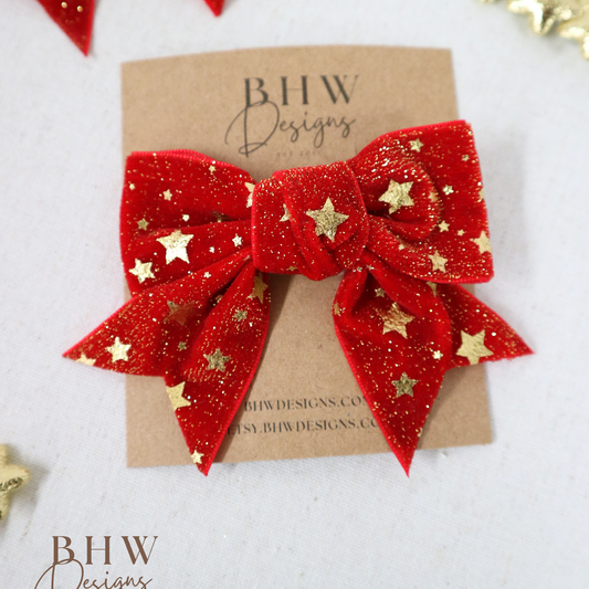 Red glittery bow with gold stars 