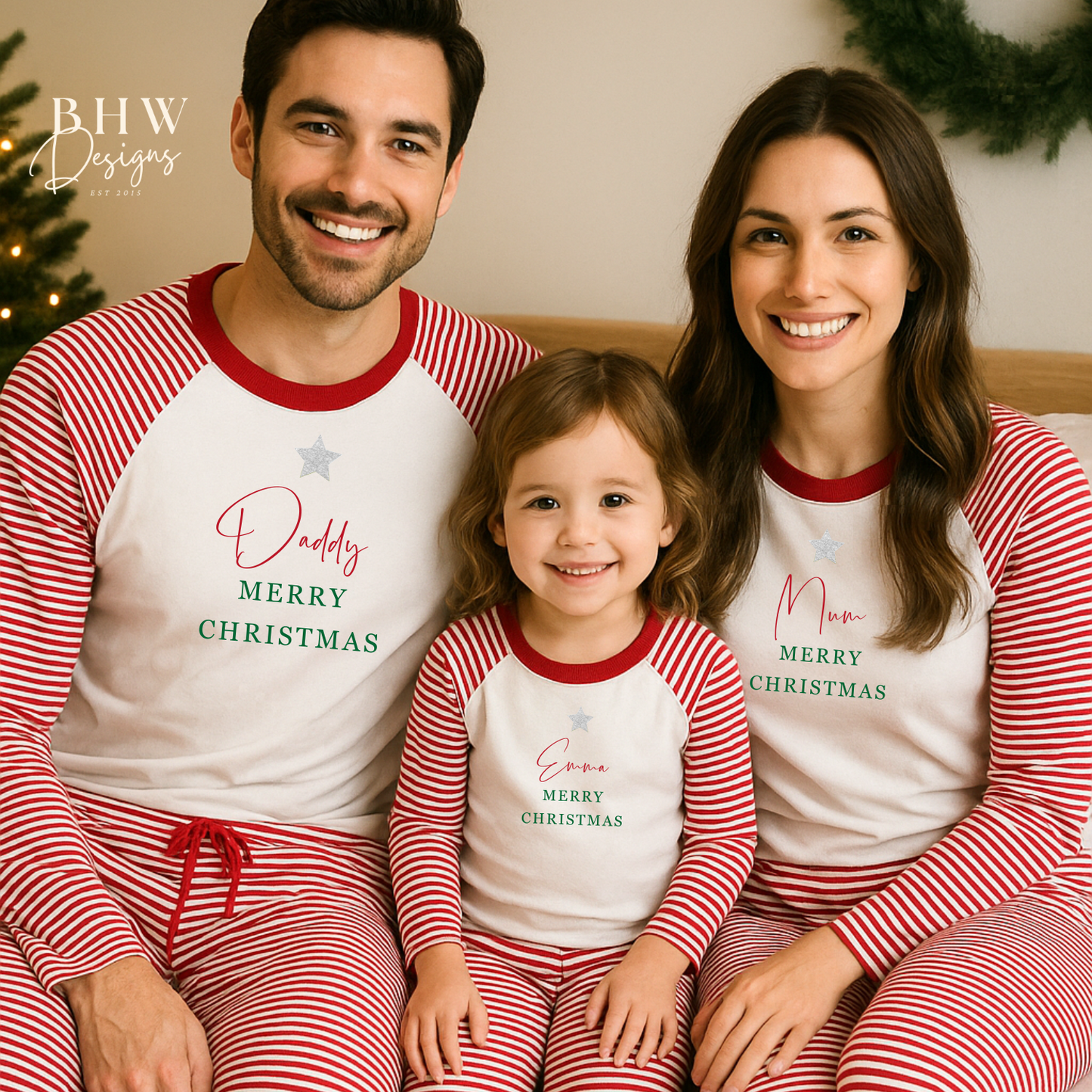 Family of three wearing matching red and white stripe Christmas pyjamas with personalised names.