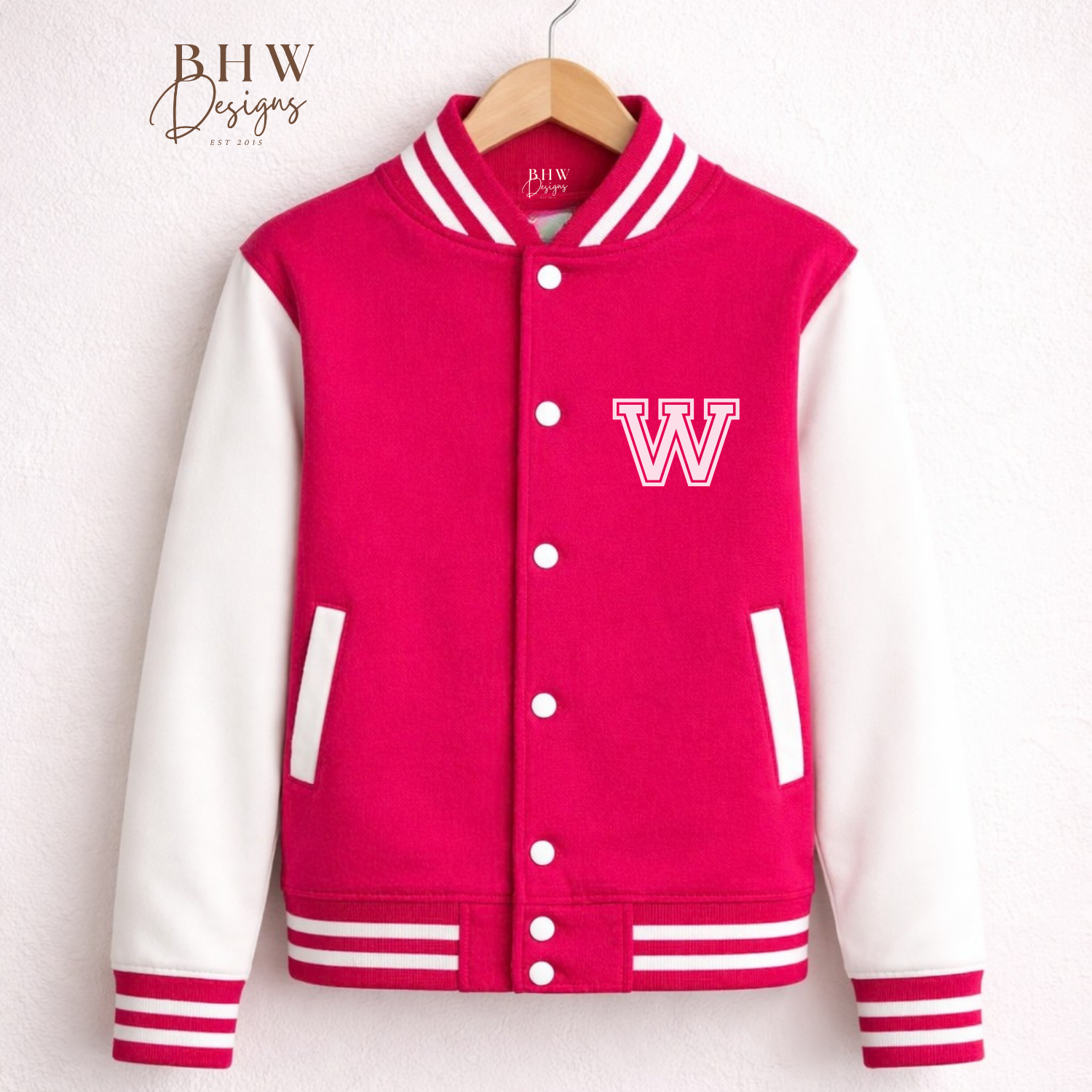 Pink varsity jacket with white sleeves on a hanger against a white background, 