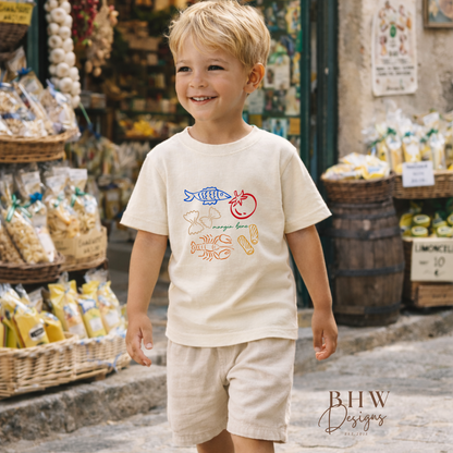 Child wearing a cream-colored t-shirt with graphics in an outdoor market setting
