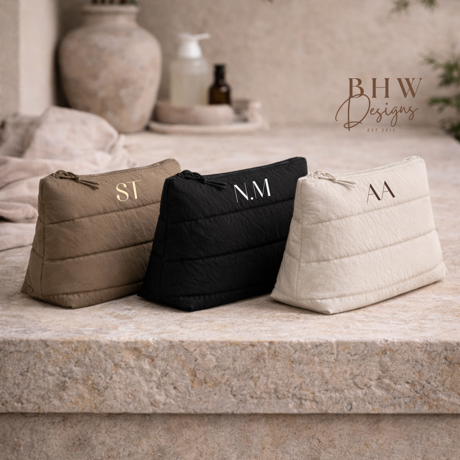 Three monogrammed bags on a stone surface with 'BHW Design' branding.