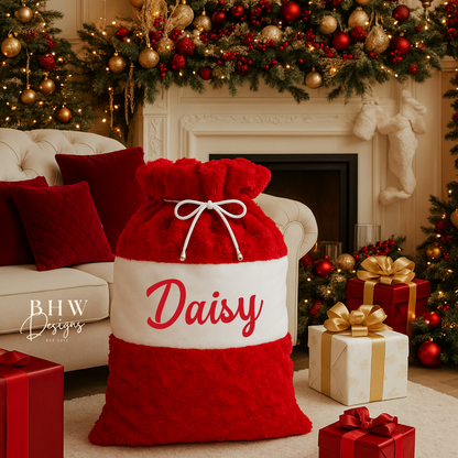 Red and white Santa Sack with 'Daisy' written on it.