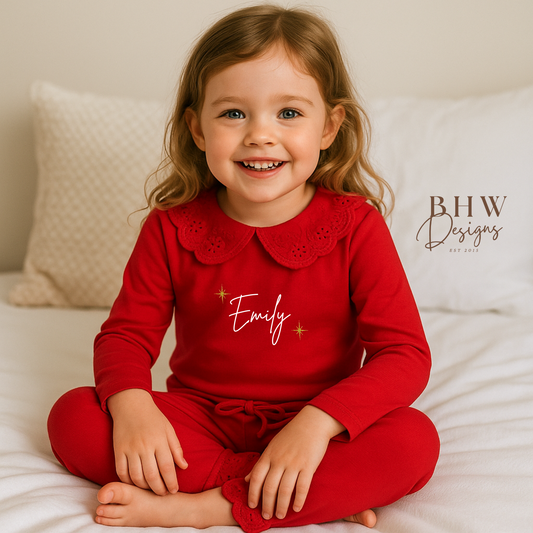 Child wearing red pyjamas with lace detail collar personalised n white with gold glitter stars 