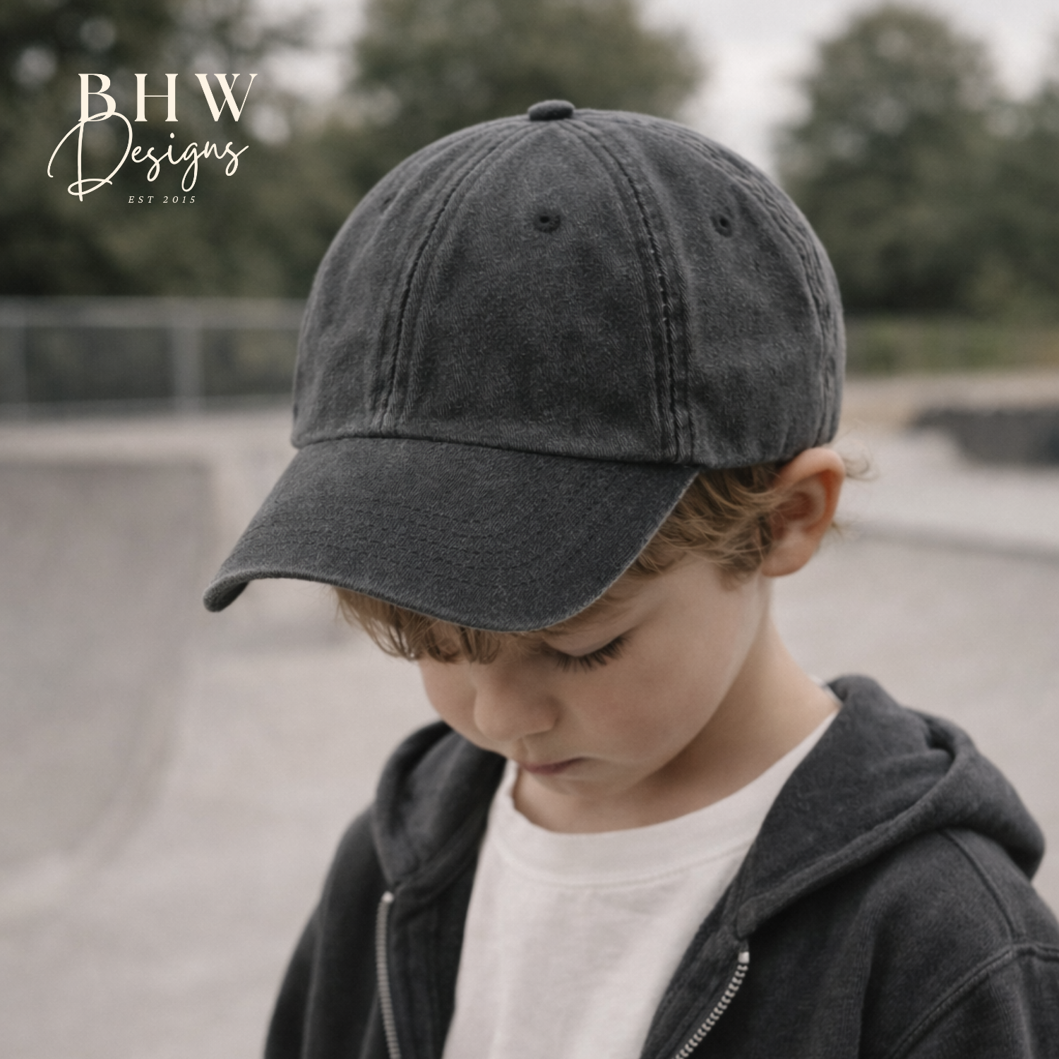 Child wearing a dark gray cap and jacket