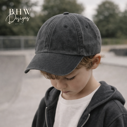 Child wearing a dark gray cap and jacket