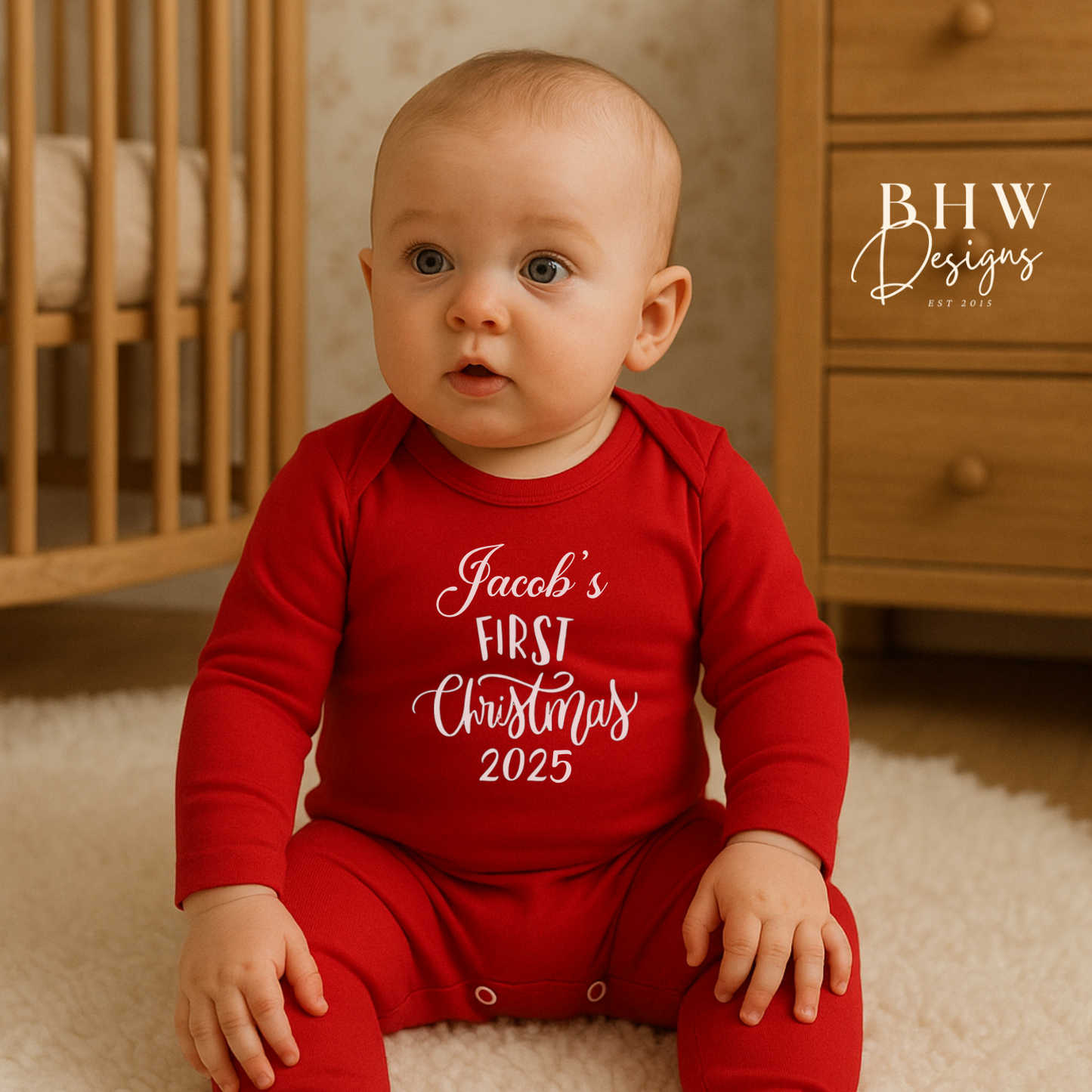 Baby wearing a red 'Jacob's First Christmas 2025' onesie 