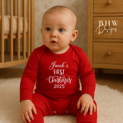 Baby wearing a red 'Jacob's First Christmas 2025' onesie 