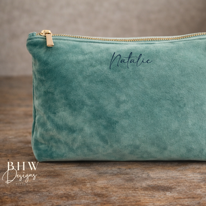Green velvet pouch with gold zipper on a wooden surface, featuring the name 'Natalie' and 'BHW Designs' branding.