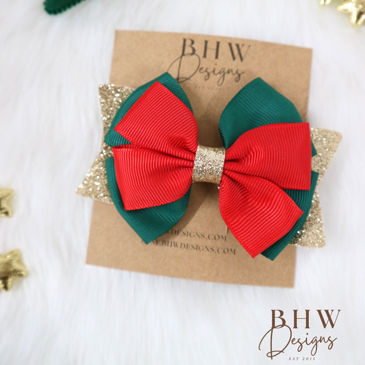 Red and green bow hair clip on a branded card