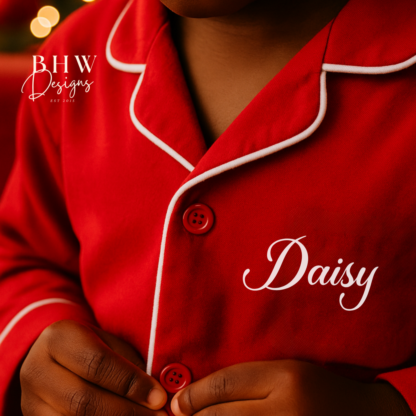 Child wearing red pyjamas with 'Daisy'  on the chest, 