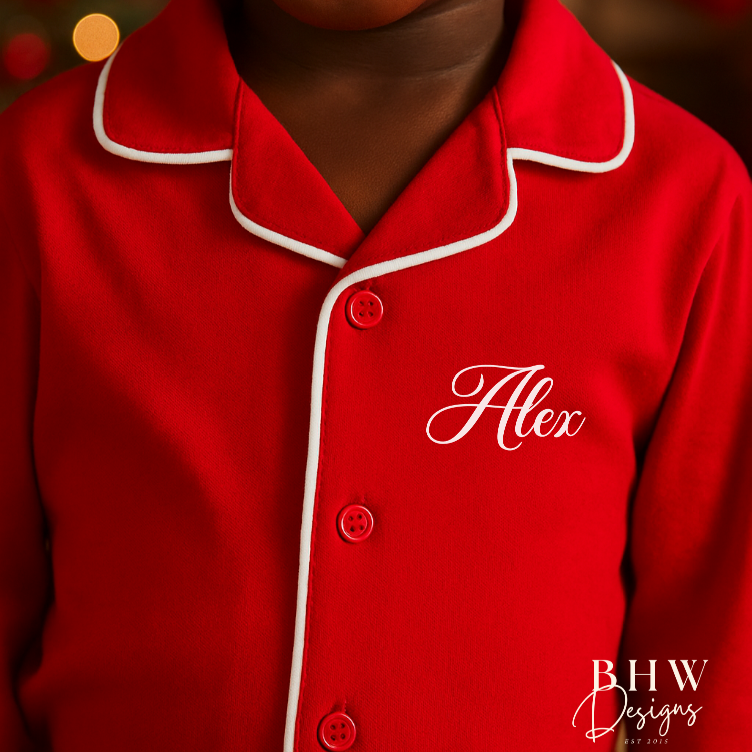 Child wearing red pyjamas with 'Alex'  on the chest.