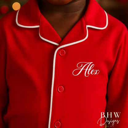 Child wearing red pyjamas with 'Alex'  on the chest.