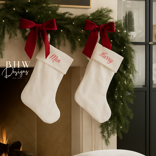 personalised Christmas stockings hanging on a fireplace with festive decorations in a cozy living room.