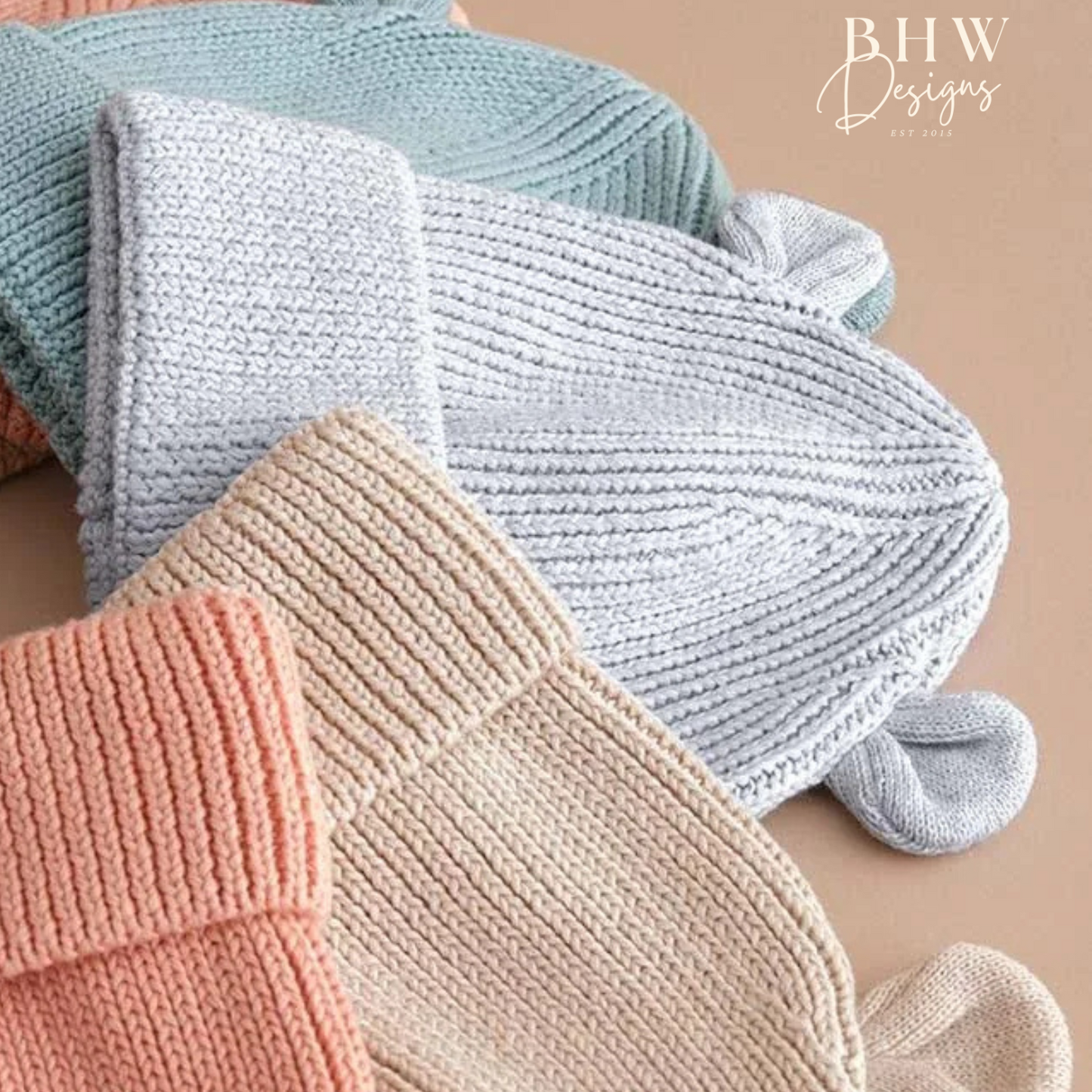 Knitted baby hats in pastel colours with bear ears