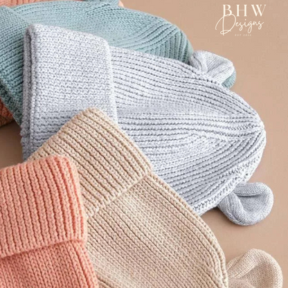 Knitted baby hats in pastel colours with bear ears