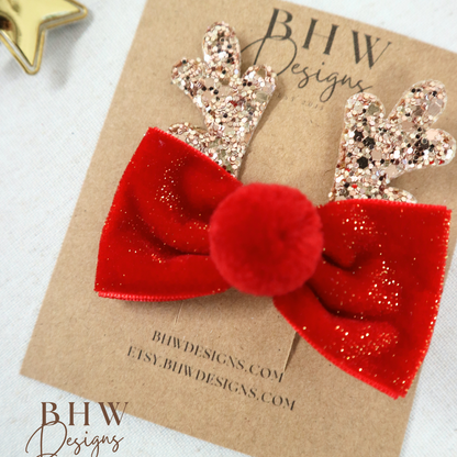 Red glittery bow with gold antlers