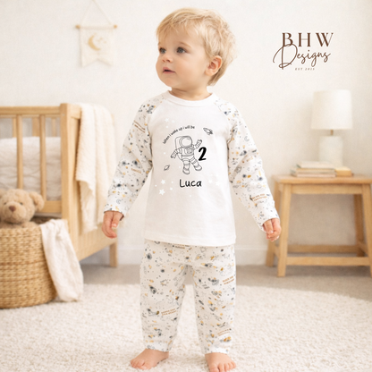 Child wearing a pyjama set with space-themed design personalised with age and name 