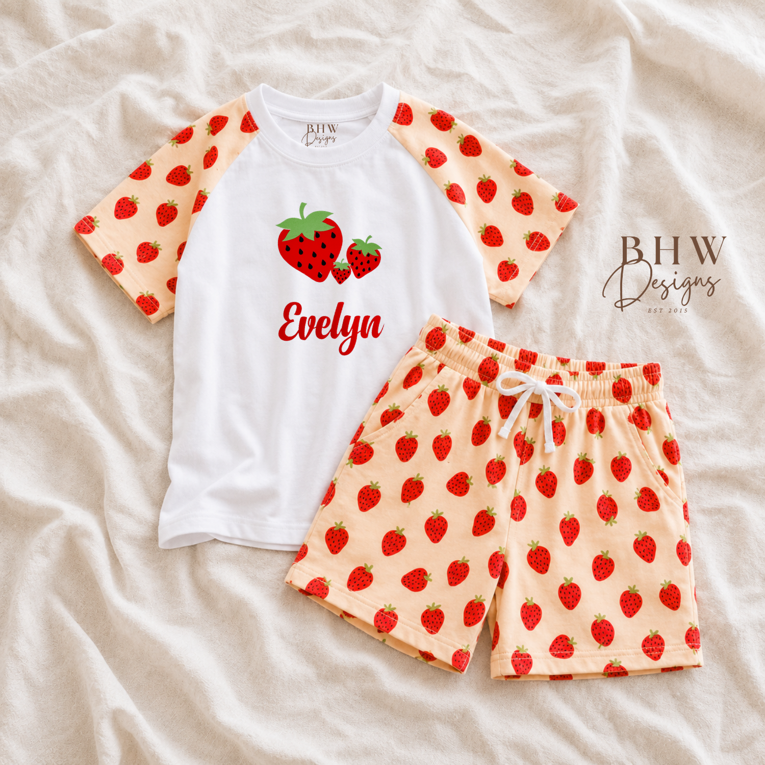 Children's pyjama set with strawberry pattern on a beige fabric background