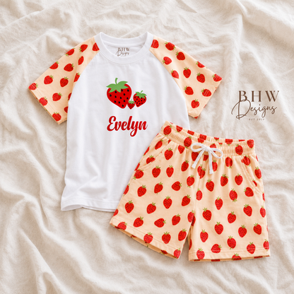 Children's pyjama set with strawberry pattern on a beige fabric background