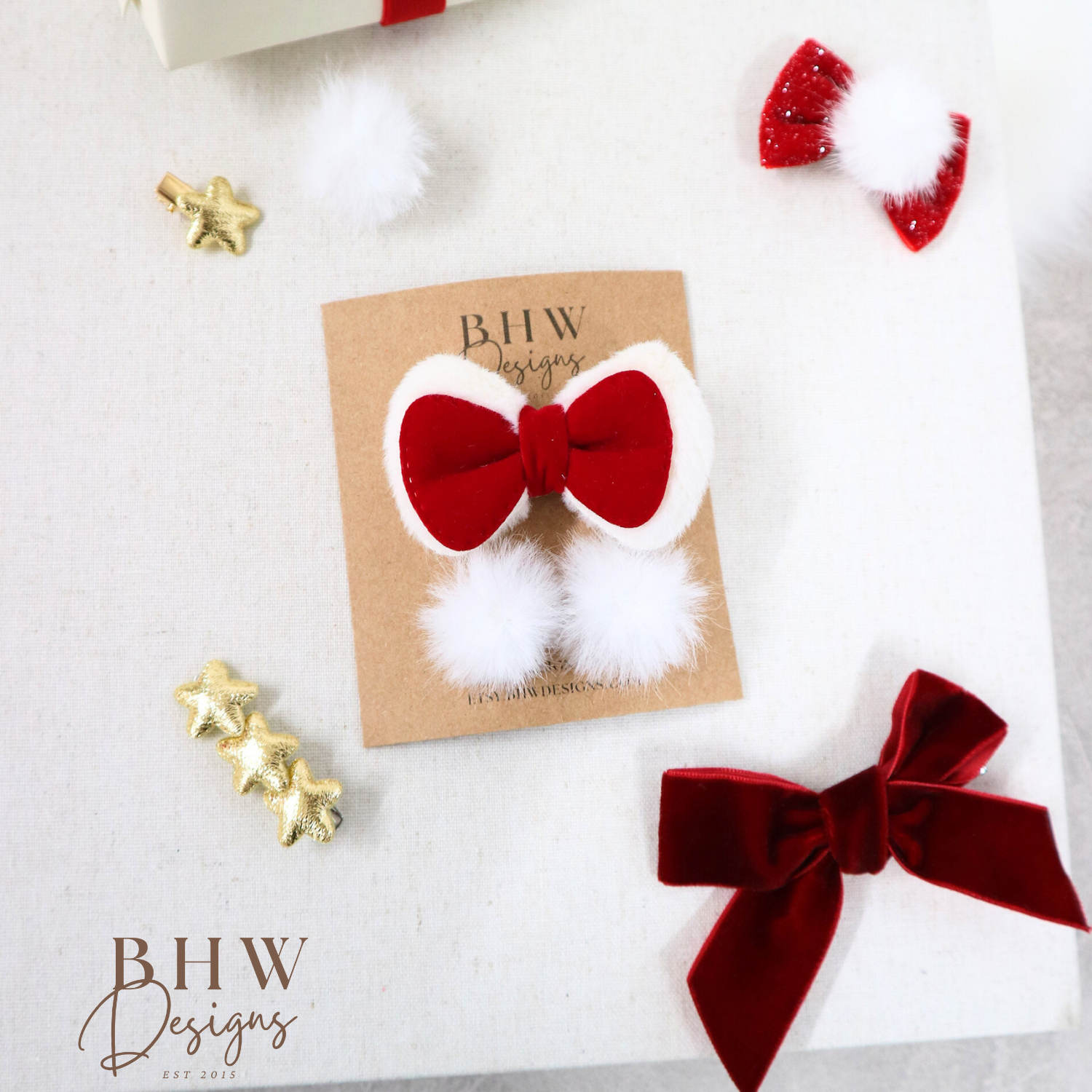 Red and white hair bow on a card with 'BHW Designs' branding, surrounded by decorative items.