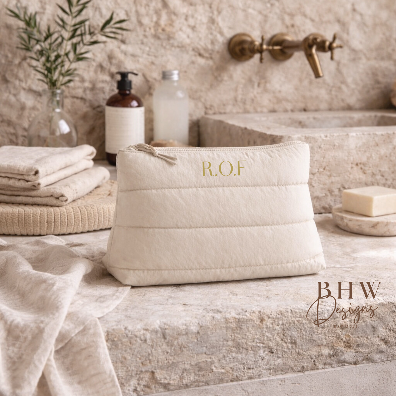 Beige bag with 'ROE' in a  a bathroom counter.
