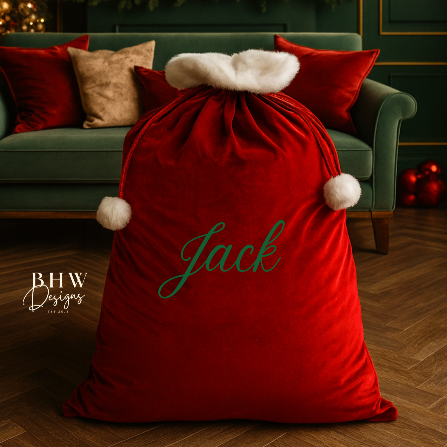 Red sack with 'Jack' on it in a festive room with candles and Christmas decorations.