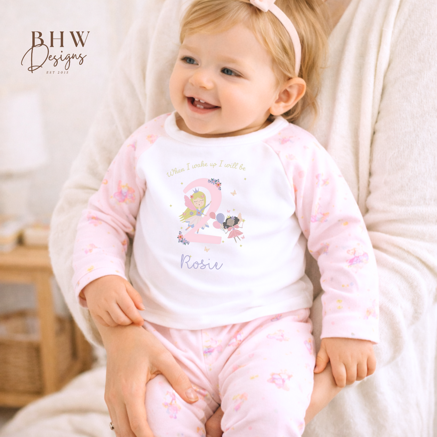 Child wearing a pink pyjamas with a fairy design, 