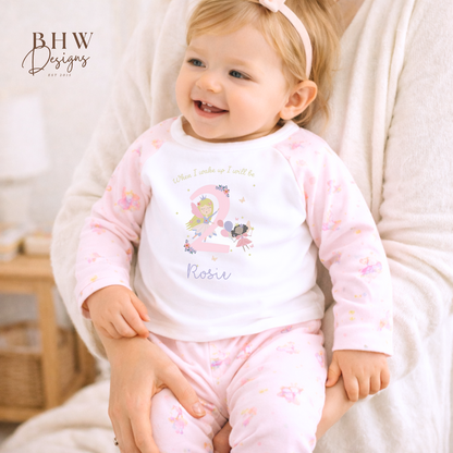 Child wearing a pink pyjamas with a fairy design, 