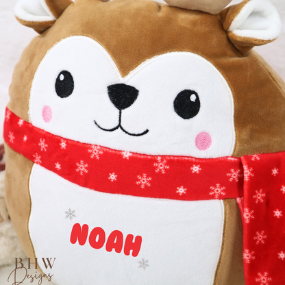 Plush reindeer toy with a red scarf and 'NOAH' text on a light background