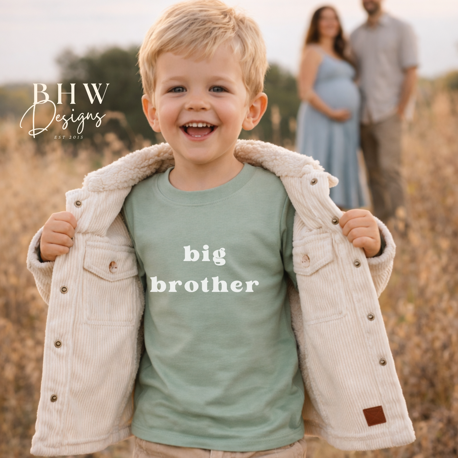 Child wearing a 'big brother' shirt with parents in the background