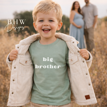 Child wearing a 'big brother' shirt with parents in the background