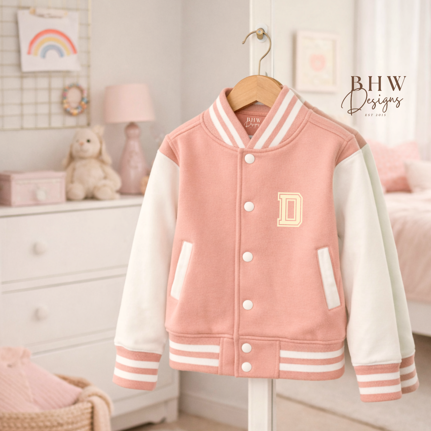 Peach Pink varsity jacket with white sleeves on a hanger in a room setting.