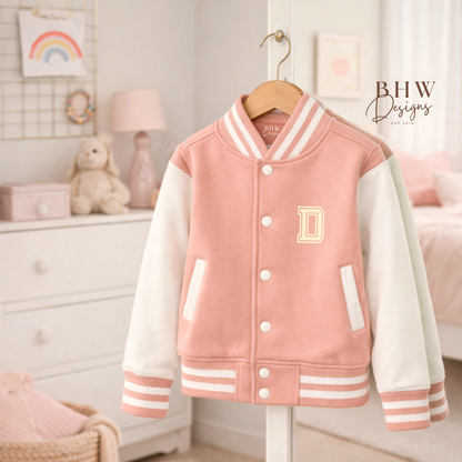 Peach Pink varsity jacket with white sleeves on a hanger in a room setting.