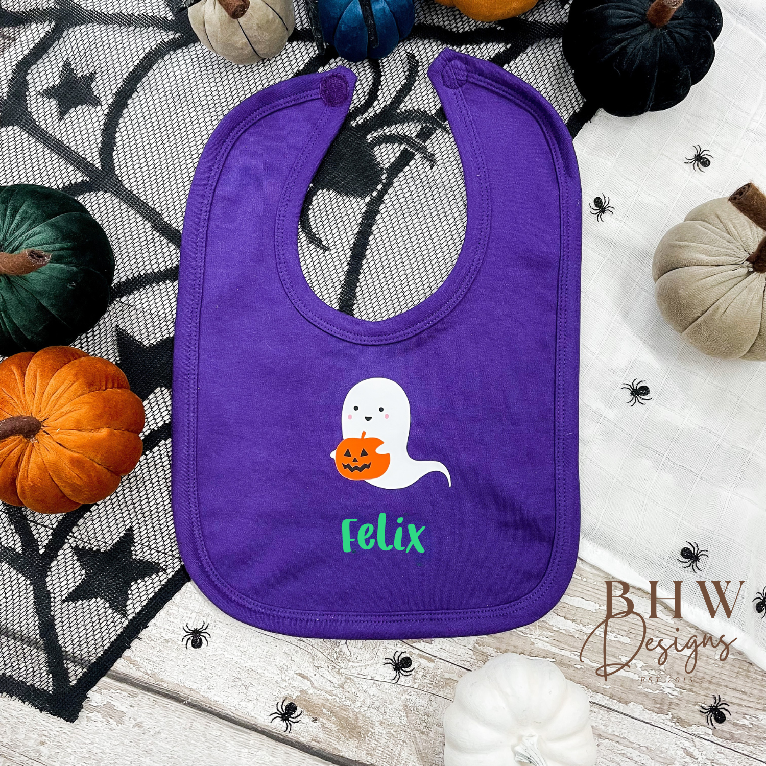 Personalised Purple bib with ghost and pumpkin design on a Halloween-themed background