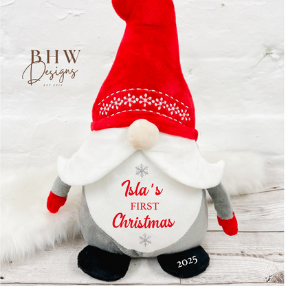 Christmas-themed gnome with red hat and white beard personalised with a name and first christmas in red with silver stars 