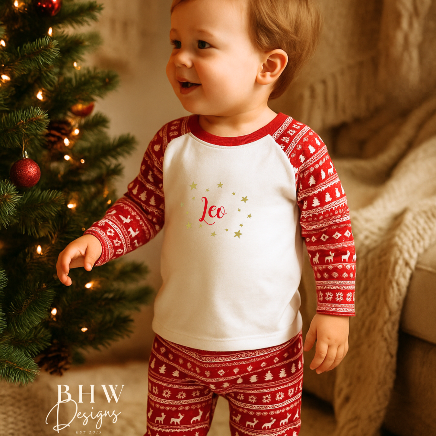 Child wearing red and white fair isle print pyjamas. 