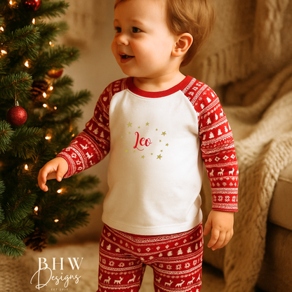 Child wearing red and white fair isle print pyjamas. 
