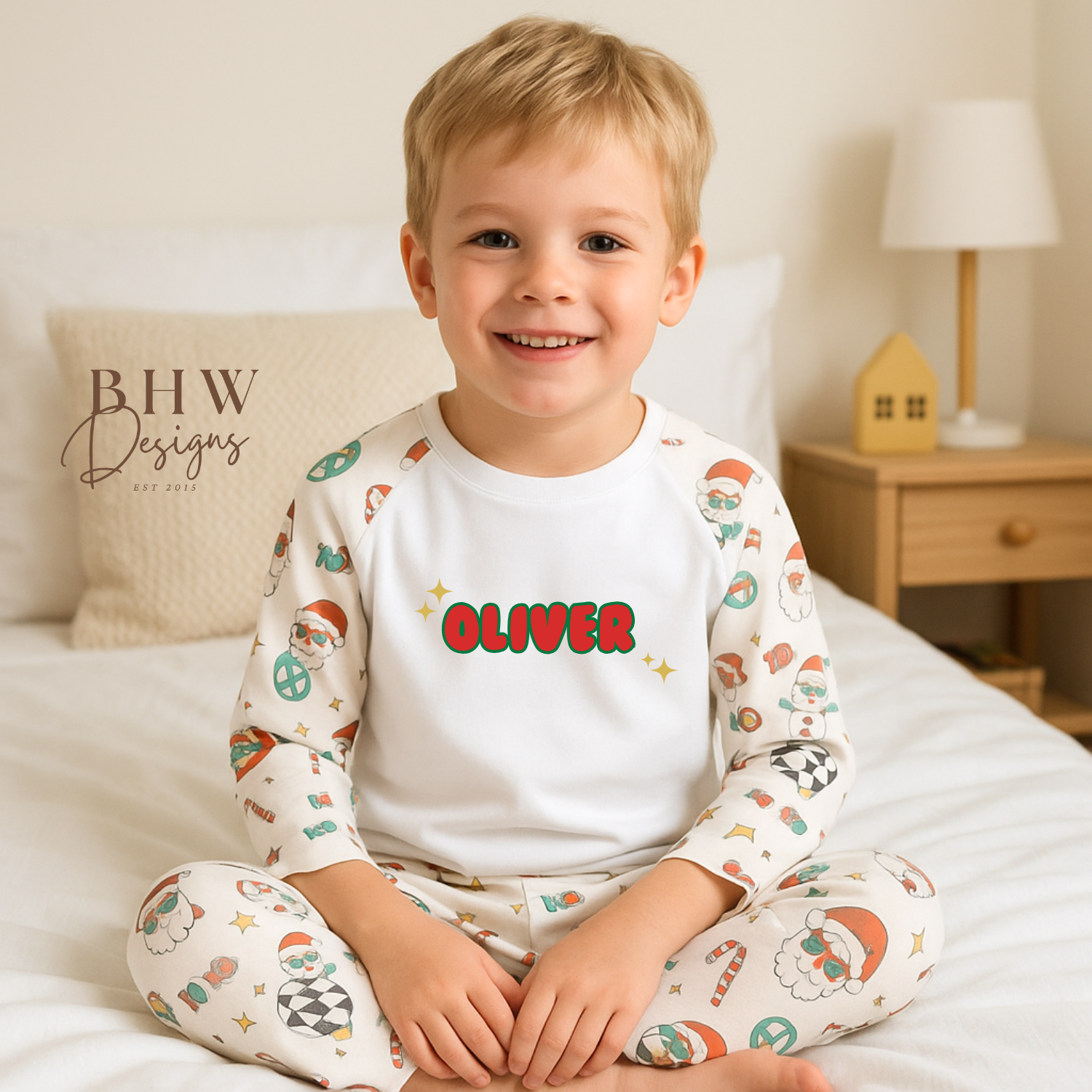 Child wearing pajamas with 'Oliver' printed on a bed, featuring BHW Designs branding.
