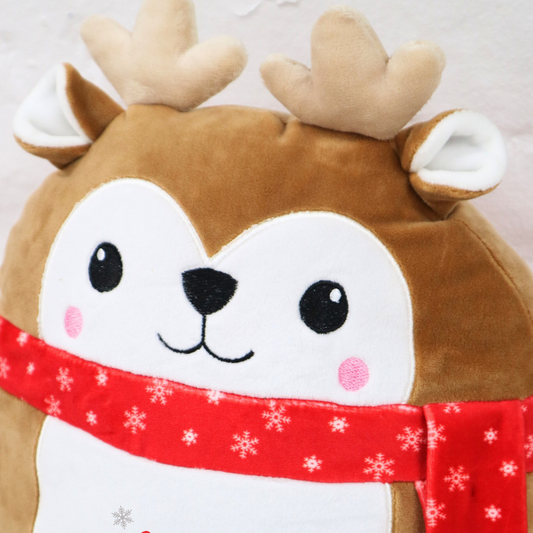 Plush reindeer pillow with a red scarf and 'MIA' on a light background