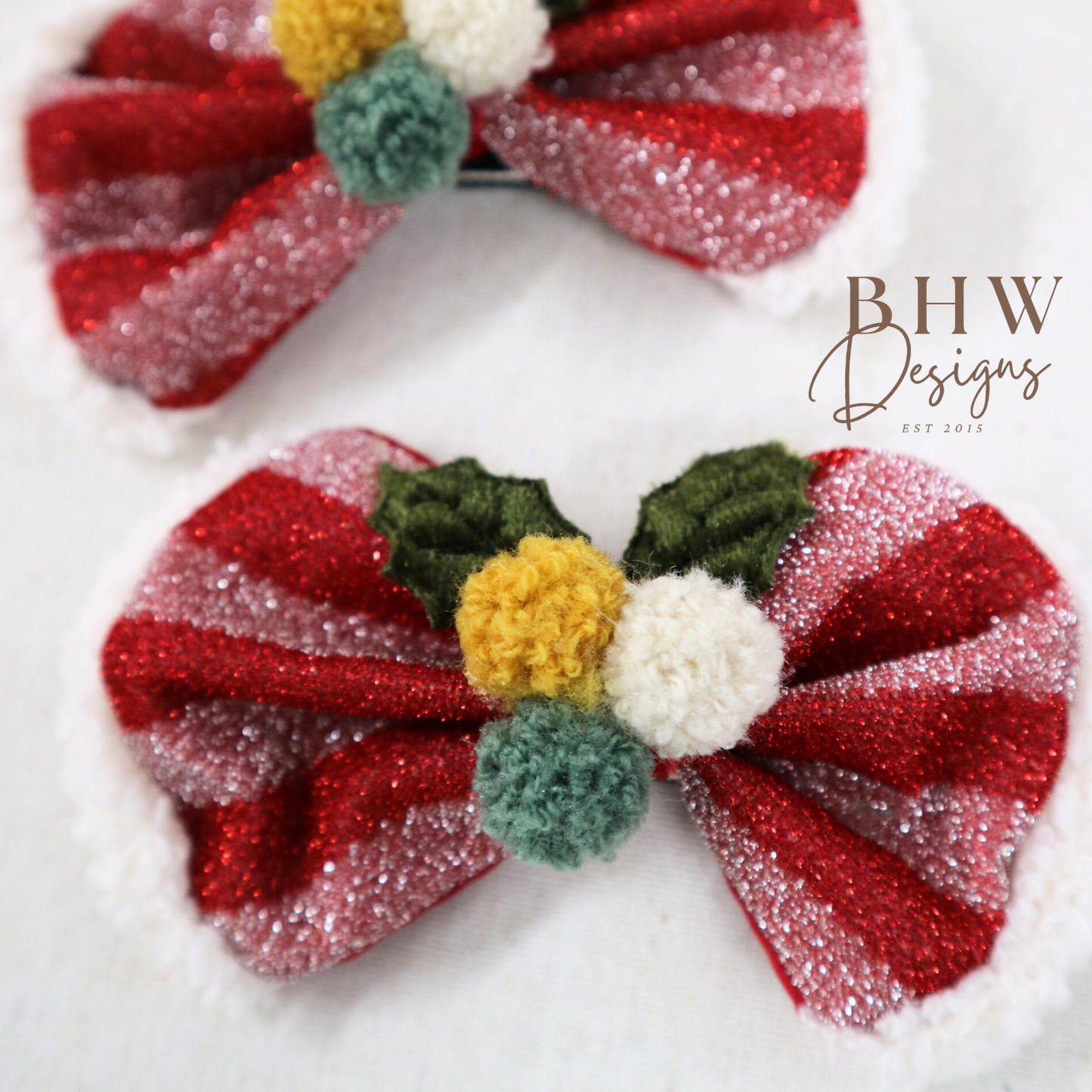 Two decorative striped bows with pom-poms on a 