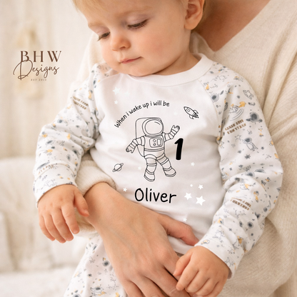 Baby wearing space-themed design pyjamas and text, saying when I wake up I will be, personalised with age and name 