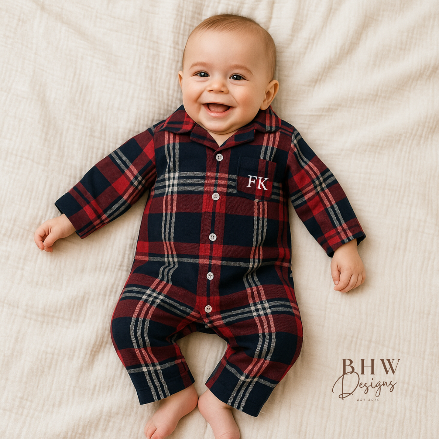 Baby wearing a red and blue plaid onesie with 'FK' on the front
