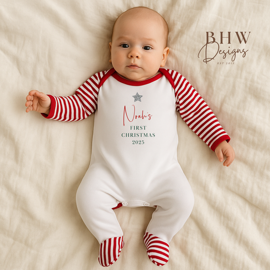 Baby wearing a red and white striped onesie with 'Noah's First Christmas 2025'