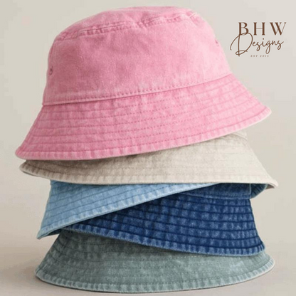 Stack of pink, beige, blue and sage green bucket hats 